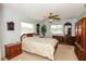 Serene main bedroom featuring a queen-sized bed, wood furnishings, and ample natural light at 2221 Bal Harbour Dr, Venice, FL 34293