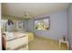 This main bedroom features a large window and carpeted floors at 2221 Bal Harbour Dr, Venice, FL 34293