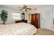 Comfortable main bedroom with a queen-sized bed, dark wood furniture, and ceiling fan at 2221 Bal Harbour Dr, Venice, FL 34293