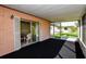 Screened-in patio offers views of the green lawn with easy access to interior, with natural light at 2221 Bal Harbour Dr, Venice, FL 34293