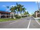Beautiful street in Venice, Florida, lined with palm trees and charming buildings under a clear blue sky at 2221 Bal Harbour Dr, Venice, FL 34293