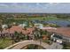 Aerial view of the Sarasota National clubhouse, pool, and surrounding community at 23138 Copperleaf Dr, Venice, FL 34293