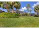 Spacious backyard with lush greenery, tropical trees, and scenic views at 23138 Copperleaf Dr, Venice, FL 34293