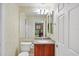 Well-lit bathroom with a single sink vanity and decorative wall paper at 23138 Copperleaf Dr, Venice, FL 34293