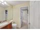 Well-lit bathroom with a single sink vanity and tiled flooring at 23138 Copperleaf Dr, Venice, FL 34293