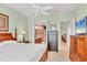 Primary bedroom with large windows, ceiling fan, and a queen bed at 23138 Copperleaf Dr, Venice, FL 34293