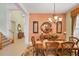Formal dining room with decorative rug, chandelier, and peach accent wall at 23138 Copperleaf Dr, Venice, FL 34293
