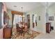 Formal dining room with decorative rug, chandelier, and peach accent wall at 23138 Copperleaf Dr, Venice, FL 34293