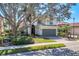 Two-story home featuring a well-maintained lawn, gray facade, tile roof, and attached two-car garage at 23138 Copperleaf Dr, Venice, FL 34293