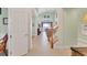 A welcoming foyer showcasing soaring ceilings, neutral tile flooring, and an open staircase at 23138 Copperleaf Dr, Venice, FL 34293