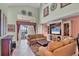 Spacious living room featuring high ceilings, tile flooring, a large entertainment center and rear yard access at 23138 Copperleaf Dr, Venice, FL 34293