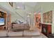 Spacious living room with soaring ceilings, fireplace, and staircase at 23138 Copperleaf Dr, Venice, FL 34293