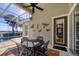 Relaxing screened-in patio with ceiling fan and decorative garden art accents at 23138 Copperleaf Dr, Venice, FL 34293