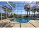 Gorgeous screened-in pool area with waterfront views and tropical landscaping at 23138 Copperleaf Dr, Venice, FL 34293