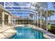 Inviting screened-in pool and spa with lounge chairs offers a relaxing outdoor experience at 23138 Copperleaf Dr, Venice, FL 34293