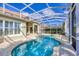 Sparkling screened-in pool and hot tub overlooking the manicured backyard at 23138 Copperleaf Dr, Venice, FL 34293
