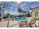 Lovely screened-in pool and spa with relaxing lounge chairs and waterfront views at 23138 Copperleaf Dr, Venice, FL 34293