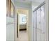 Shower with clear sliding doors, white tile surround, and a view into the bedroom at 23138 Copperleaf Dr, Venice, FL 34293