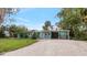 Charming single story home with beautiful landscaping, gravel driveway, and ample parking at 233 Avenida De La Isla, Nokomis, FL 34275