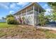 Spacious back porch with white lattice trim and well maintained landscaping at 2371 Scenic Dr, Venice, FL 34293