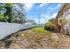 Large backyard with a white fence and green grass at 2371 Scenic Dr, Venice, FL 34293