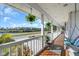 Serene balcony with hanging plants and a swing, offering stunning views of the surrounding landscape at 2371 Scenic Dr, Venice, FL 34293