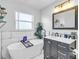 Elegant bathroom with a freestanding tub, sleek vanity, and modern fixtures at 2371 Scenic Dr, Venice, FL 34293