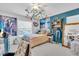 Cozy bedroom with playful decorations, blue accent wall, and comfortable bedding at 2371 Scenic Dr, Venice, FL 34293