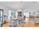 Light-filled dining room features wood floors, a large window, and modern decor at 2371 Scenic Dr, Venice, FL 34293