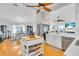 Bright kitchen featuring stainless steel appliances, a center island, and an open floor plan at 2371 Scenic Dr, Venice, FL 34293