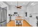 Bright kitchen with white cabinetry, stainless steel appliances, and central island seating at 2371 Scenic Dr, Venice, FL 34293