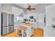 This kitchen features white cabinets, a central island with seating, and modern stainless steel appliances at 2371 Scenic Dr, Venice, FL 34293