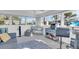 Bright sunroom featuring a comfortable seating area and home office setup at 2371 Scenic Dr, Venice, FL 34293