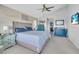 Cozy main bedroom featuring a king-size bed, accent wall, and coordinated furniture at 2371 Scenic Dr, Venice, FL 34293