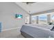 Bright main bedroom featuring a king-size bed, neutral walls and view to the exterior at 2371 Scenic Dr, Venice, FL 34293