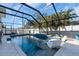 Screened pool with clear blue water, modern tile, and lounge seating for ultimate relaxation at 2371 Scenic Dr, Venice, FL 34293
