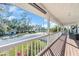 View from the expansive porch showcasing outdoor seating, a white railing and beautiful landscaping at 2371 Scenic Dr, Venice, FL 34293
