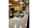 Kitchen featuring laminate countertops and warm wood cabinets and modern appliances at 2537 Northway Dr, Venice, FL 34292