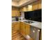 Galley kitchen featuring wood cabinets, stainless steel dishwasher, and laminate countertops at 2537 Northway Dr, Venice, FL 34292