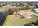 Expansive aerial view of the property showcasing the house, screened-in pool, landscaping, and waterfront location at 255 San Cristobal Ave, Punta Gorda, FL 33983