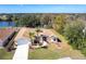 Aerial view of a charming home with a well-manicured lawn, surrounded by lush landscaping and a serene water feature at 255 San Cristobal Ave, Punta Gorda, FL 33983