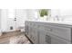 Bathroom vanity featuring gray cabinetry, double sinks, and quartz countertop at 255 San Cristobal Ave, Punta Gorda, FL 33983