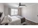 Bright bedroom featuring a ceiling fan, large window, and comfortable bed with neutral décor at 255 San Cristobal Ave, Punta Gorda, FL 33983