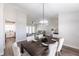 Open dining area with a modern chandelier and place settings, connecting to other rooms at 255 San Cristobal Ave, Punta Gorda, FL 33983