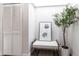 Inviting entryway with a stylish bench, palm tree art, and a decorative olive tree at 255 San Cristobal Ave, Punta Gorda, FL 33983