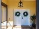 Inviting entryway featuring double doors adorned with wreaths and modern lighting at 255 San Cristobal Ave, Punta Gorda, FL 33983
