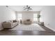 Bright living room featuring neutral furniture, wood floors, and shuttered windows at 255 San Cristobal Ave, Punta Gorda, FL 33983