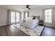 Serene main bedroom features French doors, natural light, and cozy bedding on stylish area rug at 255 San Cristobal Ave, Punta Gorda, FL 33983