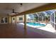 The screen enclosed pool area features tiled floors, outdoor ceiling fans, and a view of the backyard at 255 San Cristobal Ave, Punta Gorda, FL 33983