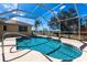 Inviting screened-in pool with clear blue water, surrounded by a spacious deck and lush landscaping at 255 San Cristobal Ave, Punta Gorda, FL 33983